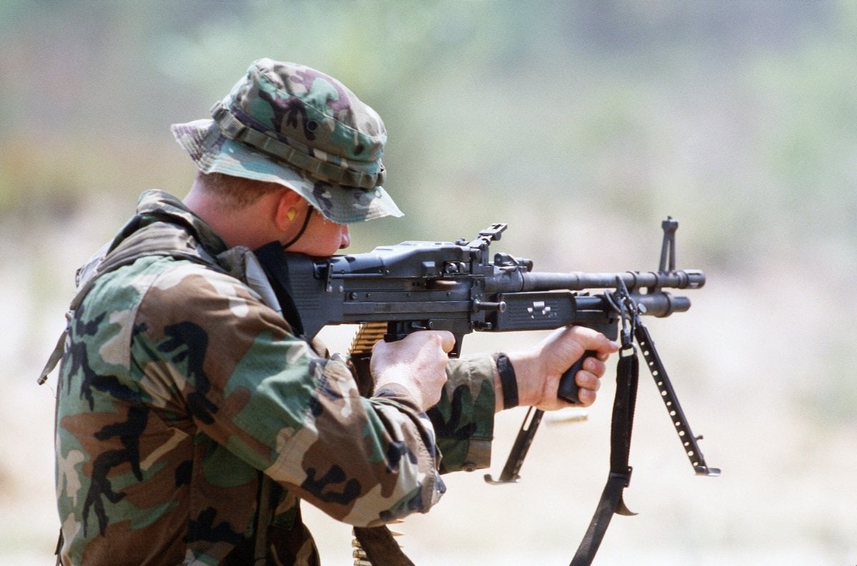 A Sea-Air-Land (SEAL) team member fires an M60 lightweight machine gun from the shoulder during a field training exercise. Image: Creative Commons.