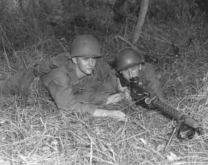 U.S. (Jerry Harrison) and W. German cadets training together - firing machine gun, W. Germany, 1960.