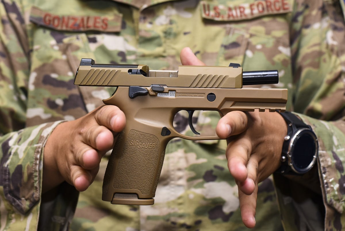 Staff Sgt. Will Gonzales, 36th Security Forces Squadron armory NCO in charge, displays a Sig Sauer M18 pistol on Andersen Air Force Base, Guam, Aug. 26, 2019. The M18 provides improved trigger pull, tritium night sights, larger ammo capacity, weapon reliability and durability to strengthen shooter lethality. (U.S. Air Force photo by Airman 1st Class Michael S. Murphy)