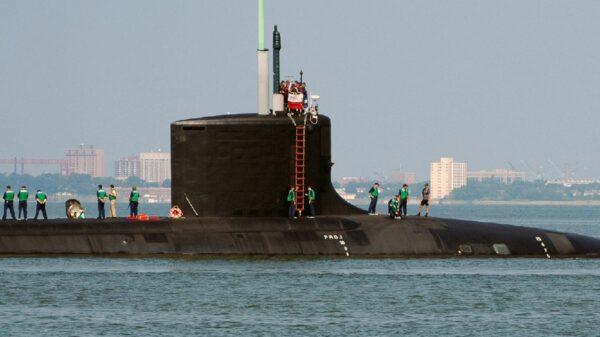 U.S. Navy Sailors stationed aboard the Virginia Class New Attack Submarine Pre-Commissioning Unit (PCU) TEXAS (SSN 775) stands topside as the boat gets underway from Naval Station Norfolk, Va., Aug. 22, 2006. TEXAS is the second Virginia Class submarine built and the first major U.S. Navy combatant vessel class designed with the post-Cold War security environment in mind. TEXAS will be commissioned Sept 9, 2006 in Galveston, Texas. (U.S. Navy photo by Mass Communication Specialist Seaman Kelvin Edwards) (Released)