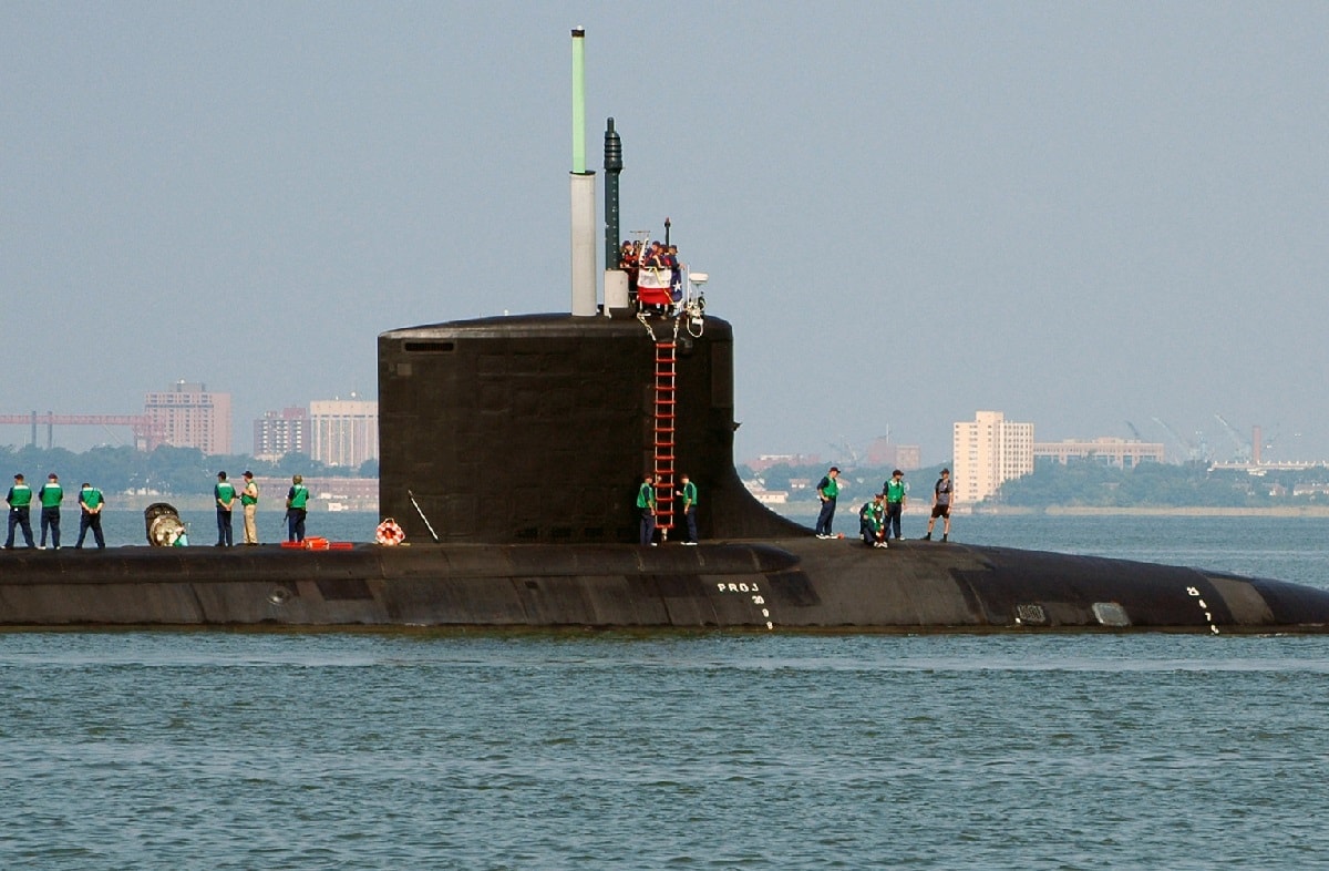 U.S. Navy Sailors stationed aboard the Virginia Class New Attack Submarine Pre-Commissioning Unit (PCU) TEXAS (SSN 775) stands topside as the boat gets underway from Naval Station Norfolk, Va., Aug. 22, 2006. TEXAS is the second Virginia Class submarine built and the first major U.S. Navy combatant vessel class designed with the post-Cold War security environment in mind. TEXAS will be commissioned Sept 9, 2006 in Galveston, Texas. (U.S. Navy photo by Mass Communication Specialist Seaman Kelvin Edwards) (Released)