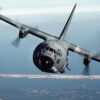 An air-to-air front view of an AC-130A Hercules gunship aircraft. The aircraft is from the 919th Special Operations Group (AFRESO), Eglin Air Force Base Auxiliary Field) 3 (Duke Field) Florida. Airman Magazine, December 1984.