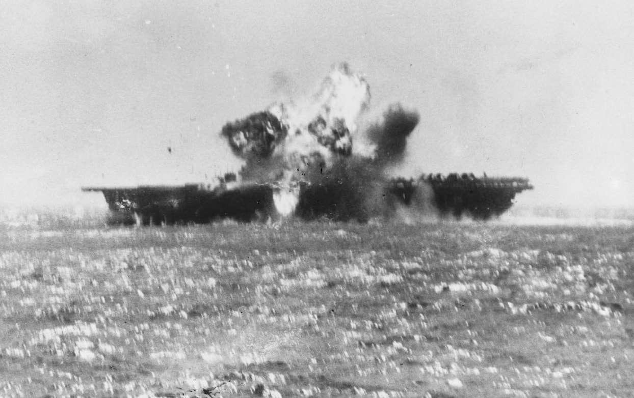 A kamikaze aircraft explodes after crashing into Essex's flight deck amidships 25 November 1944. Image Credit: Creative Commons.