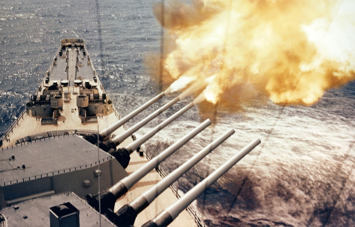 USS Wisconsin (BB-64) Fires a three-gun salvo from her forward 16/50 gun turret, during bombardment duty off Korea. Photograph is dated 30 January 1952. Official U.S. Navy Photograph, now in the collections of the National Archives.