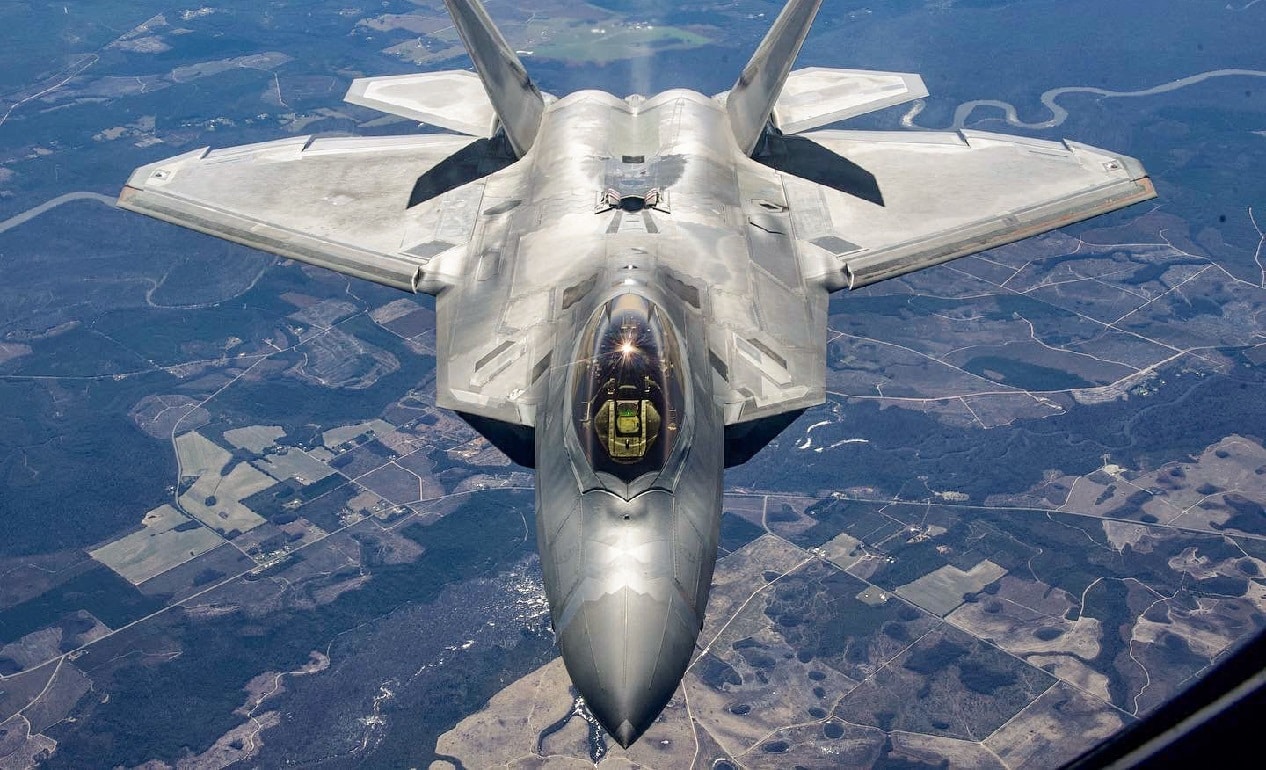 A U.S. Air Force KC-135 Stratotanker with the 434th Air Refueling Wing, Indiana, which had an aircrew with the 63rd Air Refueling Squadron, Florida, refuels a F-22 Raptor with the 325th Fighter Wing, Florida on February 23, 2021. The Stratotanker was on loan to MacDill Air Force Base. (U.S. Air Force photo by Senior Airman Tiffany A. Emery)