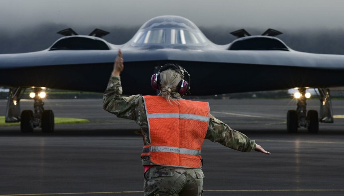 Crew chiefs assigned to the 393rd Expeditionary Bomb Squadron, prep a B-2 Spirit stealth bomber for take off, at  Lajes Field, Azores, March 16, 2021. Three B-2s, assigned to Whiteman Air Force Base, Missouri, arrived at Lajes to hot-pit refuel prior to supporting several bomber task force missions in the high north.  Strategic bomber missions are conducted periodically to enhance the readiness necessary to respond to challenges, in coordination with partner and allied nations, around the world. Members assigned to U.S. European Command regularly train, fight and live with allies and partners from bases in Europe, to ensure timely and coordinated responses when needed. (U.S. Air Force photo by Tech. Sgt. Heather Salazar)