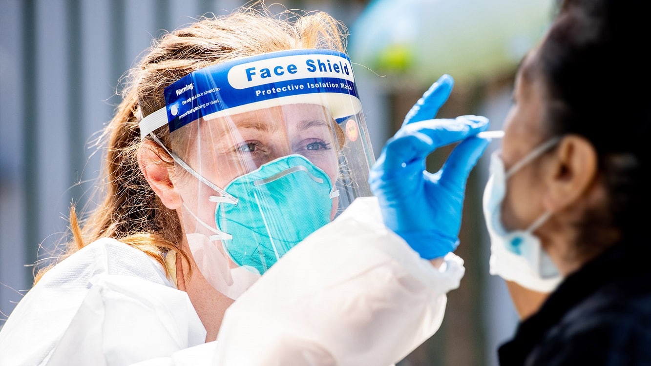 Katie Machado, RN, UCSF Nurse Practitioner Student, collects a nasal sample from a local resident at the Parque Ninos Unidos site. Image Credit: Creative Commons.