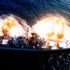 An overhead view of the battleship USS NEW JERSEY (BB-62) firing a full broadside to starboard during a main battery firing exercise. Image Credit: Creative Commons.