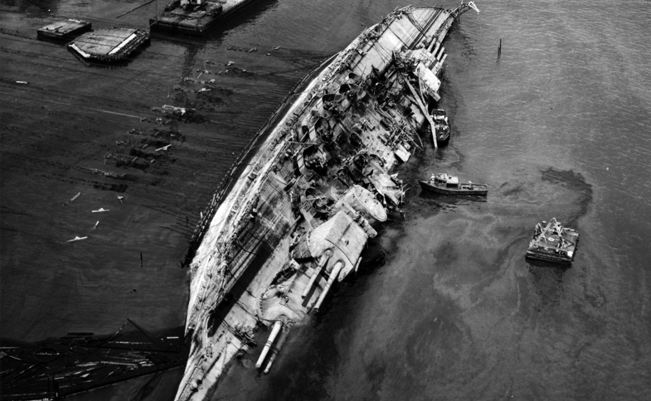 The USS Oklahoma, moored at Ford Island, Pearl Harbor, was sunk by Japanese aircraft during the attack on Pearl Harbor. A total of 429 crewmen aboard the USS Oklahoma were killed in the early morning hours of Dec. 7, 1941, after the ship quickly capsized from the numerous torpedo hits. Image Credit: Creative Commons.
