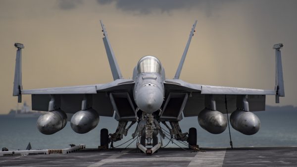 A (Feb. 5, 2021) An F/A-18E Super Hornet, from the "Kestrels" of Strike Fighter Squadron (VFA) 137, rests on the flight deck of the aircraft carrier USS Nimitz (CVN 68) during a strait transit. Nimitz is part of the Nimitz Carrier Strike Group and is deployed conducting maritime security operations and theater security cooperation efforts. (U.S. Navy photo by Mass Communication Specialist 3rd Class Elliot Schaudt/Released)