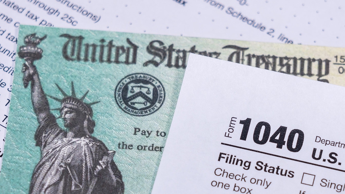 1040 and Social Security Check. Image Credit: Creative Commons.