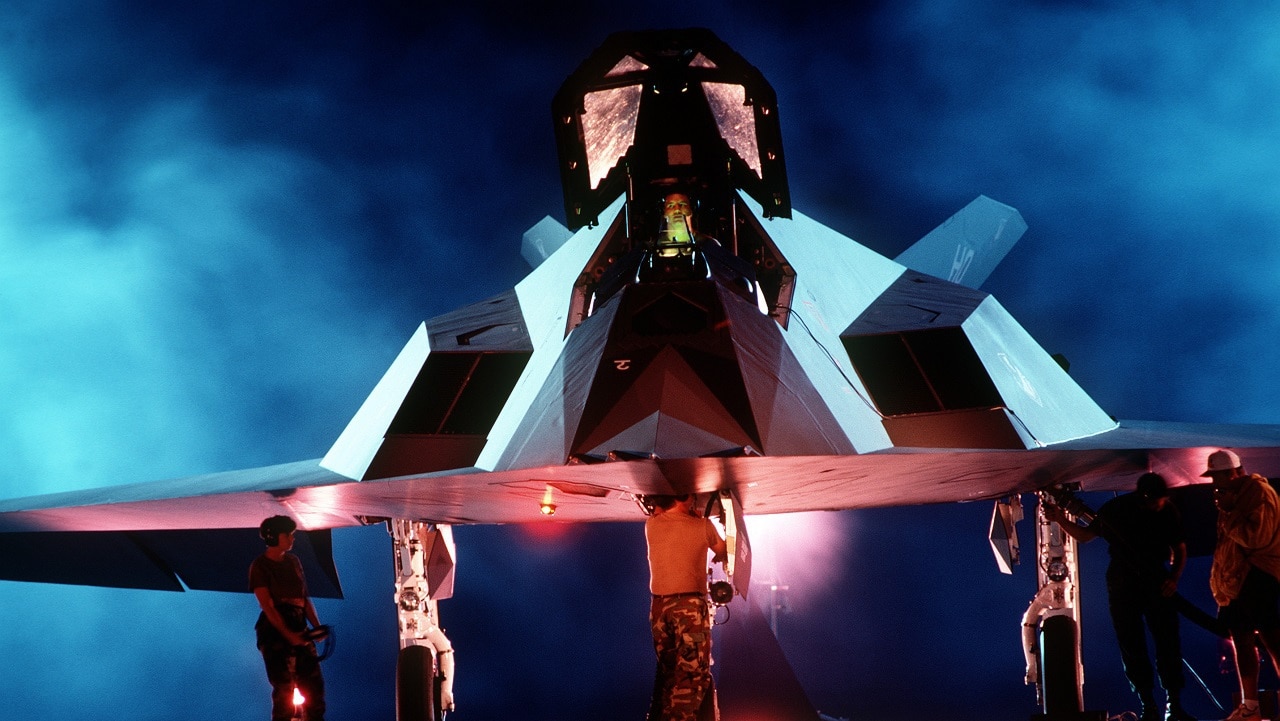 A back lit front view of a F-117A Stealth Fighter aircraft. From Airman Magazine's February 1995 issue article "Streamlining Acquisition 101".