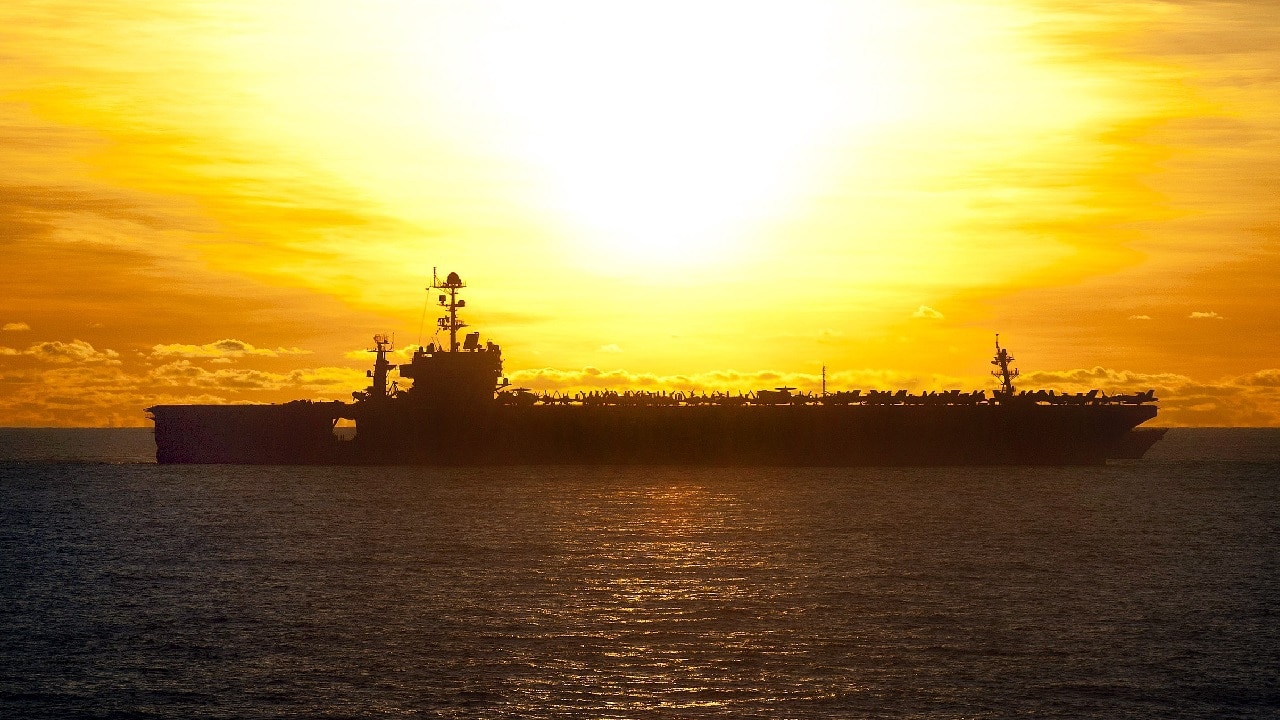 (July 8, 2012) The aircraft carrier USS George Washington (CVN 73) conducts an early morning replenishment at sea with the George Washington Strike Group. George Washington is forward deployed to Yokosuka, Japan, and is underway in the U.S. 7th Fleet area of responsibility. (U.S. Navy photo by Mass Communication Specialist 3rd Class Paul Kelly/Released) .