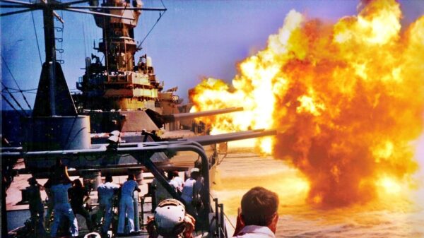 Image of US Navy battleship firing. Image Credit: Creative Commons.