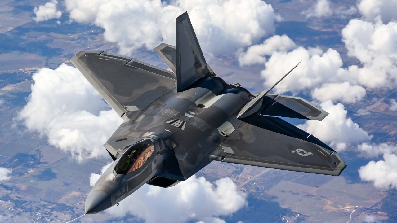 An F-22 Raptor Demonstration Team pilot flies behind a KC-135 Stratotanker from the 465th Air Refueling Squadron assigned to Tinker Air Force Base, Oklahoma, March 8. 2021. The F-22 team from Joint Base Langley–Eustis, Virginia, is assigned to Air Combat Command and received fuel from the Okies during their flight back to their home station after performing at an air show. (U.S. Air Force photo by Senior Airman Mary Begy)