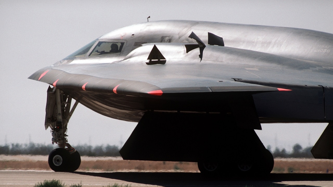 A left side view of the front of a B-2 advanced technology bomber aircraft as it prepares for its first flight, at the Air Force Flight Test Center.