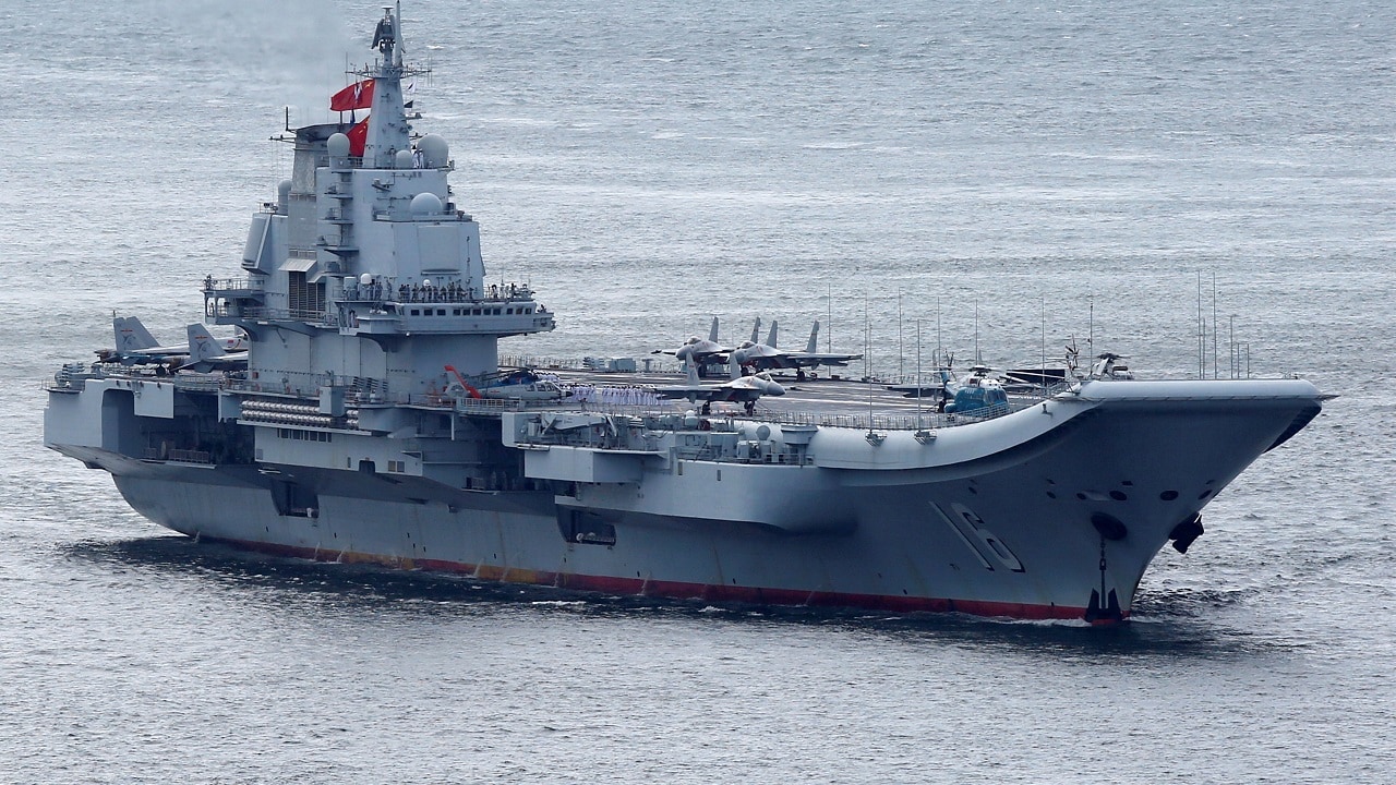 Members of the People's Liberation Army navy are seen on board China's aircraft carrier Liaoning as it sails into Hong Kong, China July 7, 2017. REUTERS/Bobby Yip