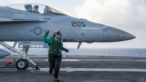 PHILIPPINE SEA (Feb. 28, 2022) Aviation Boatswain's Mate (Equipment) 3rd Class Anatalia Zamora, from Midland, Texas, runs to a safe distance before an F/A-18E Super Hornet assigned to the "Tophatters" of Strike Fighter Squadron (VFA) 14 launches from the flight deck of the Nimitz-class aircraft carrier USS Abraham Lincoln (CVN 72). The Abraham Lincoln Carrier Strike Group is on a scheduled deployment in the U.S. 7th Fleet area of operations to enhance interoperability through alliances and partnerships while serving as a ready-response force in support of a free and open Indo-Pacific region. (U.S. Navy photo by Mass Communication Specialist 3rd Class Michael Singley) 220228-N-MM912-1137