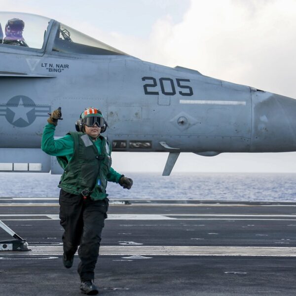 PHILIPPINE SEA (Feb. 28, 2022) Aviation Boatswain's Mate (Equipment) 3rd Class Anatalia Zamora, from Midland, Texas, runs to a safe distance before an F/A-18E Super Hornet assigned to the "Tophatters" of Strike Fighter Squadron (VFA) 14 launches from the flight deck of the Nimitz-class aircraft carrier USS Abraham Lincoln (CVN 72). The Abraham Lincoln Carrier Strike Group is on a scheduled deployment in the U.S. 7th Fleet area of operations to enhance interoperability through alliances and partnerships while serving as a ready-response force in support of a free and open Indo-Pacific region. (U.S. Navy photo by Mass Communication Specialist 3rd Class Michael Singley) 220228-N-MM912-1137
