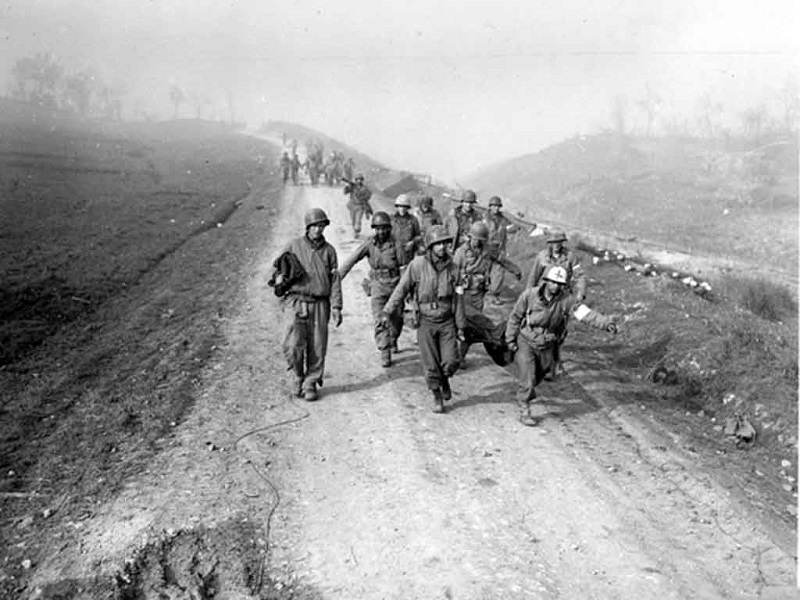 Litter bearers bring back wounded during attempt to span the Rapido River near Cassino, Italy.” 23 January 1944