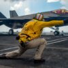 SOUTH CHINA SEA (Oct. 25, 2021) Lt. Nicholas Eppler, from Exeter, Calif., directs flight operations as an F-35C Lightning II assigned to the “Argonauts” of Strike Fighter Squadron (VFA) 147 launches from the Nimitz-class aircraft carrier USS Carl Vinson (CVN 70), Oct. 25, 2021. The Carl Vinson Carrier Strike Group is on a scheduled deployment in the U.S. 7th Fleet area of operations to enhance interoperability through alliances and partnerships while serving as a ready-response force in support of a free and open Indo-Pacific region. (U.S. Navy photo by Mass Communication Specialist Seaman Emily Claire Bennett) 211025-N-TY704-1241