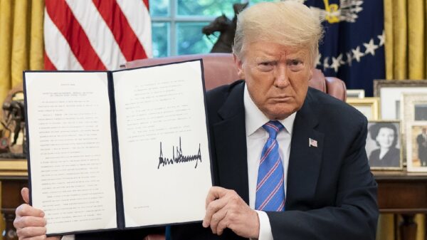 President Donald J. Trump displays his signature after signing an Executive Order on Protecting American Monuments, Memorials, and Statues and Combating Recent Criminal Violence, Friday, June 26, 2020, in the Oval Office of the White House. (Official White House Photo by Tia Dufour)