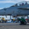 221227-N-DU622-1227 PHILIPPINE SEA (Dec. 27, 2022) An F/A-18F Super Hornet from the “Fighting Redcocks” of Strike Fighter Squadron (VFA) 22 prepares to launch from the flight deck of the aircraft carrier USS Nimitz (CVN 68). Nimitz is in 7th fleet conducting routine operations. 7th Fleet is the U.S. Navy's largest forward-deployed numbered fleet, and routinely interacts and operates with 35 maritime nations in preserving a free and open Indo-Pacific region. (U.S. Navy photo by Mass Communication Specialist 2nd Class Justin McTaggart)