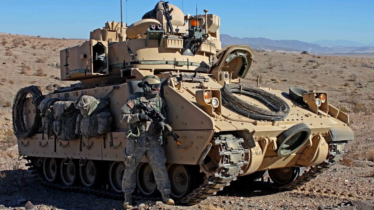 U.S. Army soldier from the 3rd Armored Brigade Combat Team, 1st Infantry Division pulls security next to a M2 Bradley Infantry Fighting Vehicle during Decisive Action rotation 13-03, Jan. 19, 2013, at the National Training Center in Fort Irwin, Calif. Decisive Action rotations are geared toward an adaptive enemy in a complex environment. (U.S. Army photo by Sgt. Eric M. Garland II/ Released)