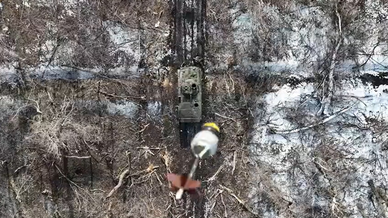 Ukraine dropping grenade on Russian BMP.