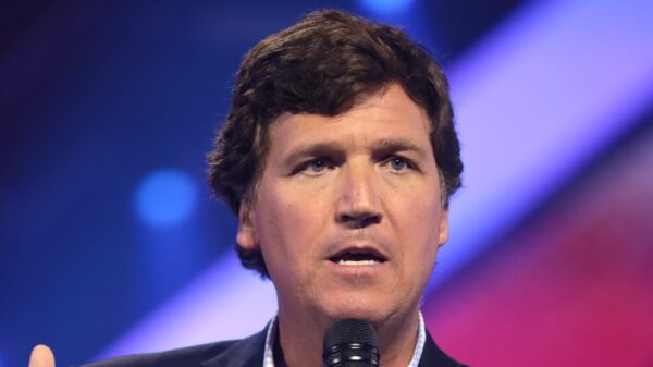 Tucker Carlson speaking with attendees at the 2022 AmericaFest at the Phoenix Convention Center in Phoenix, Arizona. By Gage Skidmore.