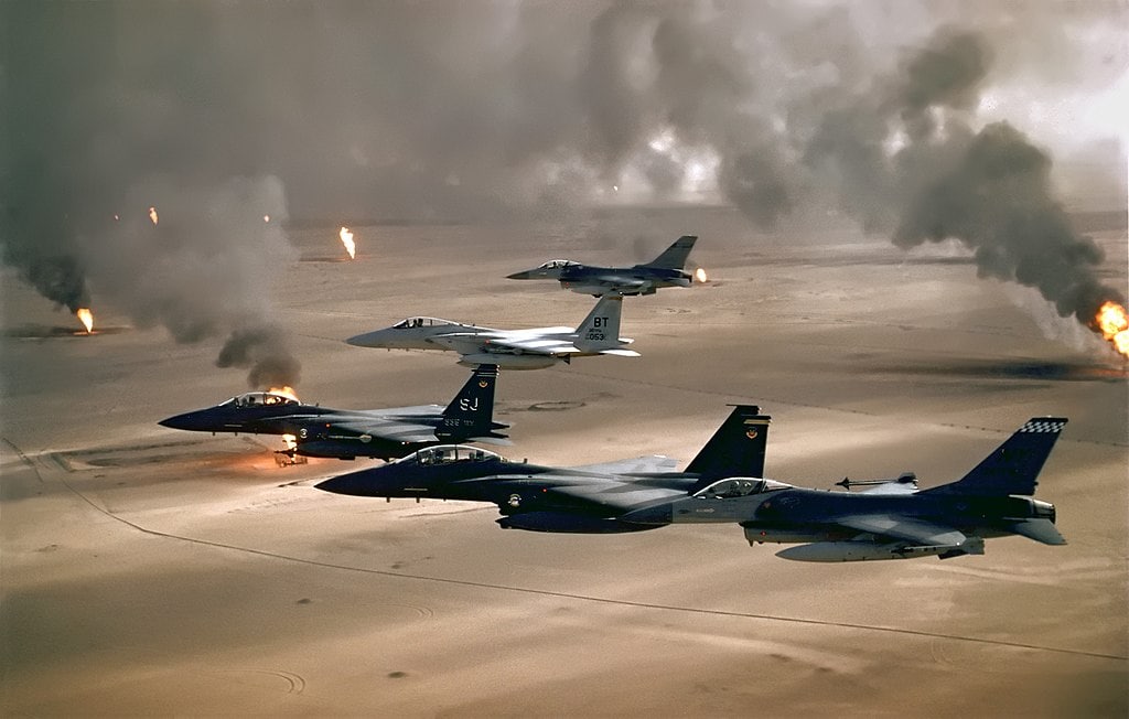 USAF aircraft fly over retreating Iraqi forces in Kuwait during Operation Desert Storm