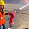 On April 20, Lauren Boebert posted a likely photoshopped picture on her Twitter account, smiling as she sprayed a water hose at a burning train. Image: Twitter.
