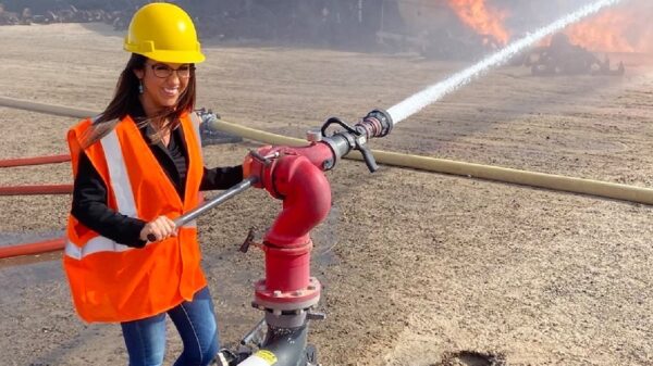 On April 20, Lauren Boebert posted a likely photoshopped picture on her Twitter account, smiling as she sprayed a water hose at a burning train. Image: Twitter.