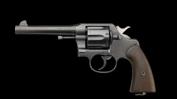 Image: Creative Commons - M1917 Revolver issued by US Army during WWI to Charles H. Houston - left DATE: January 1918 Colt Model 1917 Revolver .45 ACP (Automatic Colt Pistol) No 22-883 issued by the United States Army to Charles Hamilton Houston during World War I. The gun is comprised of metal with wood applied to the handle. The revolver has a six-round cylinder that is semi-removable so bullets can be loaded. There are multiple manufacturer's notes throughout the barrel and frame. On the left of the barrel, text reads [COLT D.A. 45]. On top of the barrel is the manufacture's information, [COLT’S PT FA MFG CO. HARTFORD, CT U.S.A. / PAT’D AUG. 5, 1884 JUNE 6 1900 JULY 4 1905]. On the left side of the frame, at the top next to the hammer are the letters [GHS] in a circle. Below the hammer on the frame is a horse standing on its hind legs with two spears. The bottom of the grip has a circular hinge with a cylinder shaped metal. Surrounding the hinge are the words, [U.S. / ARMY / MODEL / 1917 / N° / 22 / 883]. Collection of the Smithsonian National Museum of African American History and Culture, Gift of Charles Hamilton Houston, Jr. and Dr. Rosemary Jagus Object number: 2018.59.3