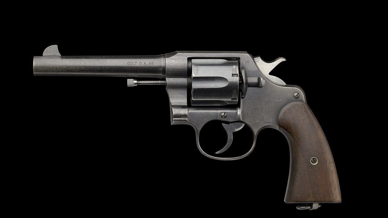 Image: Creative Commons - M1917 Revolver issued by US Army during WWI to Charles H. Houston - left DATE: January 1918 Colt Model 1917 Revolver .45 ACP (Automatic Colt Pistol) No 22-883 issued by the United States Army to Charles Hamilton Houston during World War I. The gun is comprised of metal with wood applied to the handle. The revolver has a six-round cylinder that is semi-removable so bullets can be loaded. There are multiple manufacturer's notes throughout the barrel and frame. On the left of the barrel, text reads [COLT D.A. 45]. On top of the barrel is the manufacture's information, [COLT’S PT FA MFG CO. HARTFORD, CT U.S.A. / PAT’D AUG. 5, 1884 JUNE 6 1900 JULY 4 1905]. On the left side of the frame, at the top next to the hammer are the letters [GHS] in a circle. Below the hammer on the frame is a horse standing on its hind legs with two spears. The bottom of the grip has a circular hinge with a cylinder shaped metal. Surrounding the hinge are the words, [U.S. / ARMY / MODEL / 1917 / N° / 22 / 883]. Collection of the Smithsonian National Museum of African American History and Culture, Gift of Charles Hamilton Houston, Jr. and Dr. Rosemary Jagus Object number: 2018.59.3