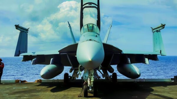 Capt. Tim Waits, commanding officer of Nimitz-class aircraft carrier USS George Washington (CVN 73), climbs into an F/A-18F Super Hornet, attached to Strike Fighter Squadron (VFA) 102, while underway in the South China Sea, Nov. 24, 2025. George Washington is the U.S. Navy’s premier forward-deployed aircraft carrier, a long-standing symbol of the United States’ commitment to maintaining a free and open Indo-Pacific region, while operating alongside allies and partners across the U.S. Navy’s largest numbered fleet. (U.S. Navy photo by Mass Communication Specialist 2nd Class Geoffrey L. Ottinger)