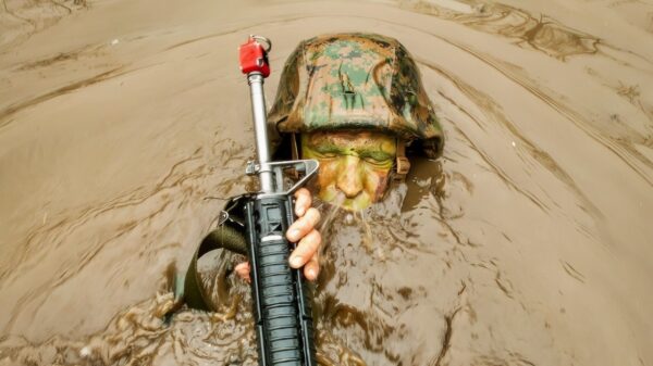 A candidates assigned to Delta Company, Officer Candidates Class-221, breaks the surface of the murky water of 'The Quigley' at Brown Field, Marine Corps Base Quantico, Va., on March 15, 2016. The mission of Officer Candidates School (OCS) is to "educate and train officer candidates in Marine Corps knowledge and skills within a controlled, challenging, and chaotic environment in order to evaluate and screen individuals for the leadership, moral, mental, and physical qualities required for commissioning as a Marine Corps officer." (U.S. Marine Corps Photo by Cpl. Patrick H. Owens/Released)