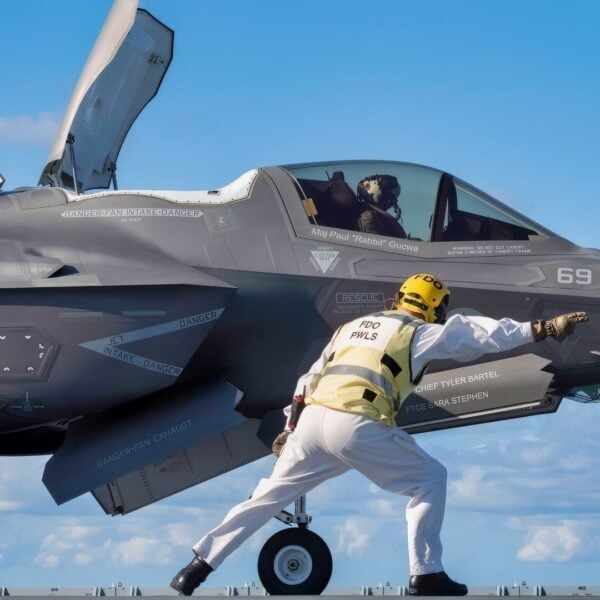 The HMS Prince of Wales (R09) aircraft carrier flight deck officer “shoots” an F-35B Lightning II short takeoff vertical landing (STOVL) variant fighter jet for a STO launch from a ski jump aboard the U.K.’s newest carrier Oct. 24, 2023. The 5th generation strike aircraft for Navy, Air Force, Marines, and allies is aboard to conduct developmental test phase 3 (DT-3) flight trials, which continue today. During the ship's deployment to the U.S. Eastern Seaboard for WESTLANT 2023, a Pax River F-35 Integrated Test Force (Pax ITF) team is working closely with the ship's company to conduct the sea trials that continue pushing the boundaries of carrier aviation. (Photo by Michael D. Jackson)