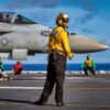 A U.S. Sailor signals to an F/A-18E Super Hornet aircraft, attached to Strike Fighter Squadron 87, during flight deck operations on the flight deck of the world’s largest aircraft carrier, Ford-class aircraft carrier USS Gerald R. Ford (CVN 78), while underway in the Caribbean Sea, Jan. 3, 2026. U.S. military forces are deployed to the Caribbean in support of the U.S. Southern Command mission, Department of War-directed operations, and the president’s priorities to disrupt illicit drug trafficking and protect the homeland. (U.S. Navy photo)