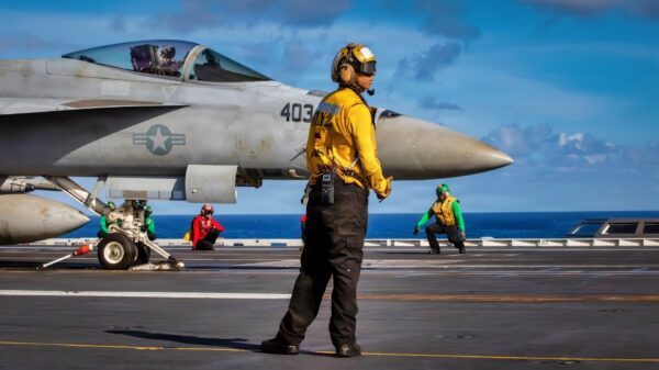 A U.S. Sailor signals to an F/A-18E Super Hornet aircraft, attached to Strike Fighter Squadron 87, during flight deck operations on the flight deck of the world’s largest aircraft carrier, Ford-class aircraft carrier USS Gerald R. Ford (CVN 78), while underway in the Caribbean Sea, Jan. 3, 2026. U.S. military forces are deployed to the Caribbean in support of the U.S. Southern Command mission, Department of War-directed operations, and the president’s priorities to disrupt illicit drug trafficking and protect the homeland. (U.S. Navy photo)