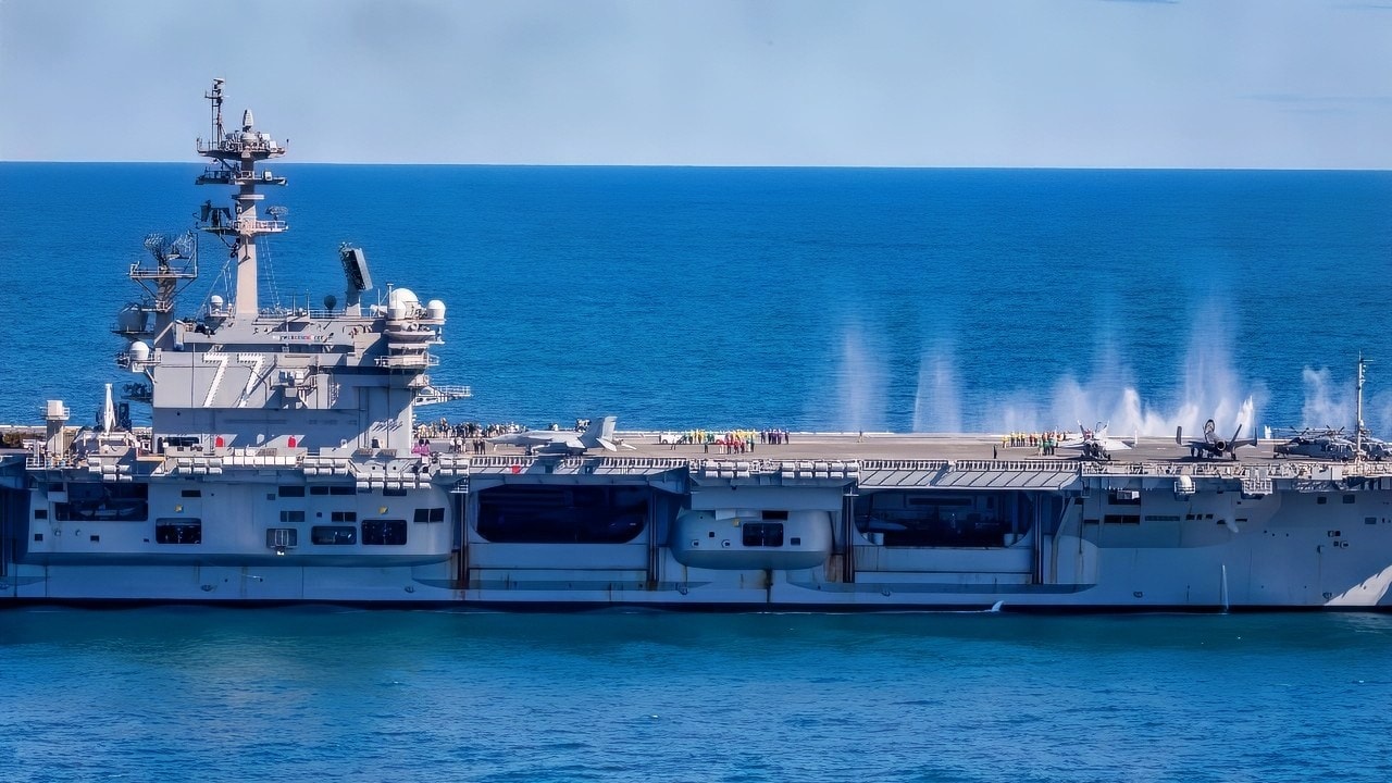 ATLANTIC OCEAN (Oct. 5, 2025) The Nimitz-class aircraft carrier USS George H.W. Bush (CVN 77) transits the Atlantic Ocean while an F/A-18E Super Hornet, attached to the “Pukin Dogs” of Strike Fighter Squadron (VFA) 143 fire rounds into ocean in support of the Titans of the Sea Presidential Review. The Titans of the Sea Presidential Review is one of many events taking place throughout the country to showcase maritime capabilities as part of the U.S Navy’s 250th birthday. America is a maritime nation. For 250 years, America’s Warfighting Navy has sailed the globe in defense of freedom. (U.S. Navy photo by Mass Communication Specialist 2nd Class Mitchell Mason)
