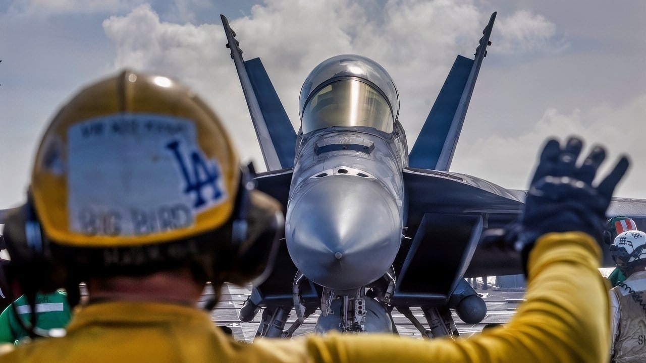 U.S. Navy Aviation Boatswain’s Mate (Handling) 2nd Class Michael Cordova directs an F/A-18E Super Hornet, attached to Strike Fighter Squadron (VFA) 14, on the flight deck of Nimitz-class aircraft carrier USS Abraham Lincoln (CVN 72) on Jan. 10, 2026. The Abraham Lincoln Carrier Strike Group is underway conducting routine operations in the U.S. 7th Fleet area of operations. Units assigned to 7th Fleet conduct regular Indo-Pacific patrols to deter aggression, strengthen alliances and partnerships, and advance peace through strength. (U.S. Navy photo by Mass Communication Specialist Seaman Daniel Kimmelman)