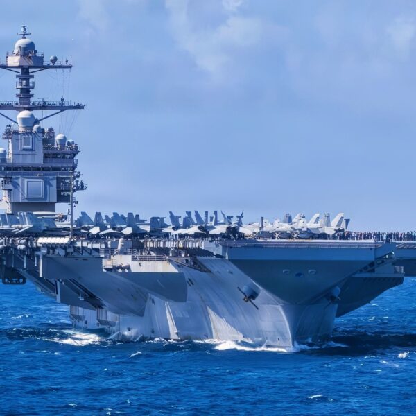U.S. Navy Carrier Air Wing 8 aircraft fly in formation over the world’s largest aircraft carrier, Ford-class aircraft carrier USS Gerald R. Ford (CVN 78), during Carrier Air Wing 8’s aerial change of command ceremony while underway in the Caribbean Sea, Jan. 19, 2026. U.S. military forces are deployed to the Caribbean in support of the U.S. Southern Command mission, Department of War-directed operations, and the president’s priorities to disrupt illicit drug trafficking and protect the homeland. (U.S. Navy photo)