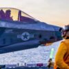 Chief Aviation Boatswain’s Mate (Handling) Stephane Togue, assigned to Wasp-class amphibious assault ship USS Makin Island (LHD 8), prepares to signal an F-35B Lightning II, attached to Marine Fighter Attack Squadron 211, for takeoff, Dec. 4, 2025. Makin Island is currently underway conducting routine operations in the U.S. 3rd Fleet. (Photo by Mass Communication Specialist Seaman Abraham Ramirez)