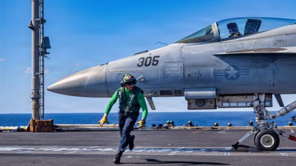 A U.S. Sailor moves behind a flight deck foul line before the launch an F/A-18E Super Hornet aircraft, attached Strike Fighter Squadron 31, from the flight deck of the world’s largest aircraft carrier, Ford-class aircraft carrier USS Gerald R. Ford (CVN 78), while underway in the Caribbean Sea, Feb. 5, 2026. U.S. military forces are deployed to the Caribbean in support of the U.S. Southern Command mission, Department of War-directed operations, and the president’s priorities to disrupt illicit drug trafficking and protect the homeland. (U.S. Navy photo)