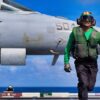 A U.S. Sailor signals the launch of an E/A-18G Growler aircraft, attached to Electronic Attack Squadron 142, from the flight deck of the world’s largest aircraft carrier, Ford-class aircraft carrier USS Gerald R. Ford (CVN 78), while underway in the Caribbean Sea, Jan. 31, 2026. U.S. military forces are deployed to the Caribbean in support of the U.S. Southern Command mission, Department of War-directed operations, and the president’s priorities to disrupt illicit drug trafficking and protect the homeland. (U.S. Navy photo)