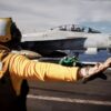 A U.S. Sailor signals to send the aircraft catapult shuttle forward on the flight deck of the world’s largest aircraft carrier, Ford-class aircraft carrier USS Gerald R. Ford (CVN 78), while underway in the Caribbean Sea, Jan. 11, 2026. U.S. military forces are deployed to the Caribbean in support of the U.S. Southern Command mission, Department of War-directed operations, and the president’s priorities to disrupt illicit drug trafficking and protect the homeland. (U.S. Navy photo)