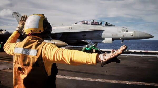 A U.S. Sailor signals to send the aircraft catapult shuttle forward on the flight deck of the world’s largest aircraft carrier, Ford-class aircraft carrier USS Gerald R. Ford (CVN 78), while underway in the Caribbean Sea, Jan. 11, 2026. U.S. military forces are deployed to the Caribbean in support of the U.S. Southern Command mission, Department of War-directed operations, and the president’s priorities to disrupt illicit drug trafficking and protect the homeland. (U.S. Navy photo)