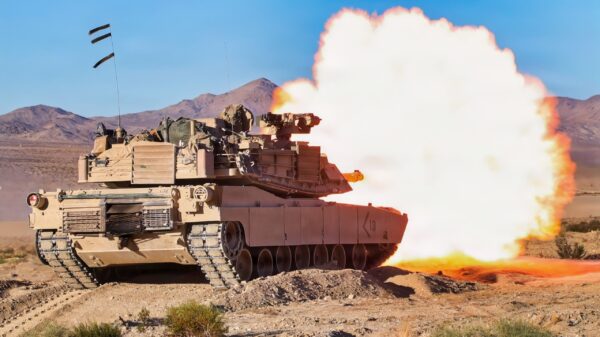 U.S. Soldiers assigned to the 1st Armored Brigade Combat Team, 1st Armored Division fire at a target from an M1 Abrams main battle tank during Rotation 26-01 at the National Training Center, Fort Irwin, Calif., Oct. 17, 2025. Rotations at the National Training Center ensure Army Brigade Combat Teams remain versatile, responsive, and consistently available for future and current contingencies. (U.S. Army photo by Cpl. Anna Mae Tumacder, Operations Group, National Training Center)