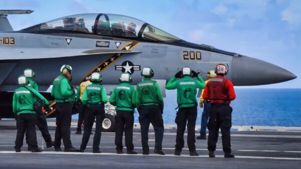 ATLANTIC OCEAN (Aug. 1, 2018) Sailors stand by as an F/A-18E Super Hornet from Strike Fighter Squadron (VFA) 103 taxies to a catapult on the flight deck aboard the Nimitz-class aircraft carrier USS Abraham Lincoln (CVN 72). (U.S. Navy photo by Mass Communication Specialist 3rd Class Jeff Sherman)